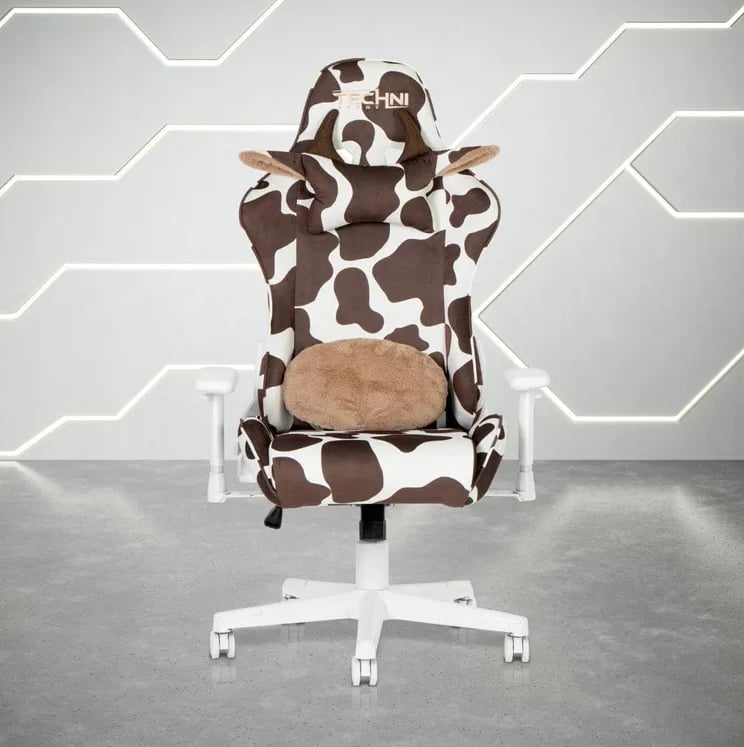 Gaming chair with brown and white cow print design and beige seat cushion on white base against geometric gray background